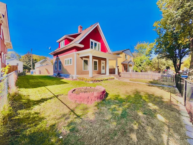 rear view of house with a yard