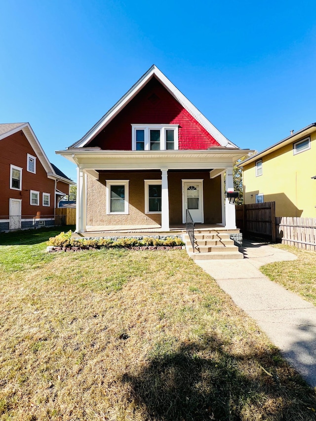 bungalow-style house featuring a front lawn and covered porch