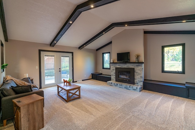 living room featuring french doors, lofted ceiling with beams, carpet flooring, and a brick fireplace