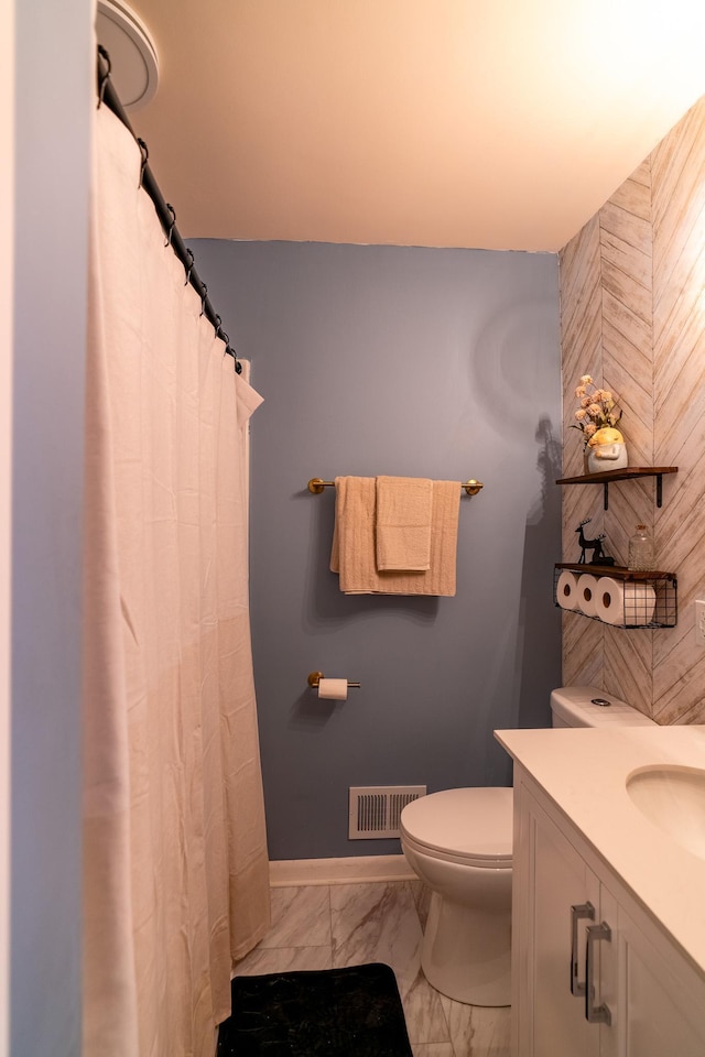 bathroom featuring vanity and toilet