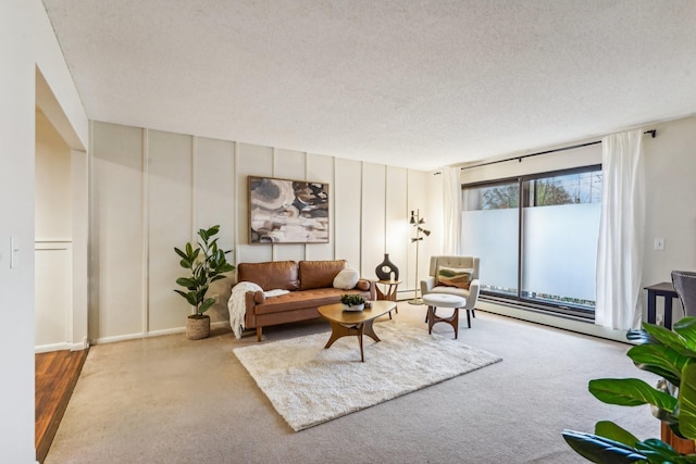 living room featuring light colored carpet and a textured ceiling