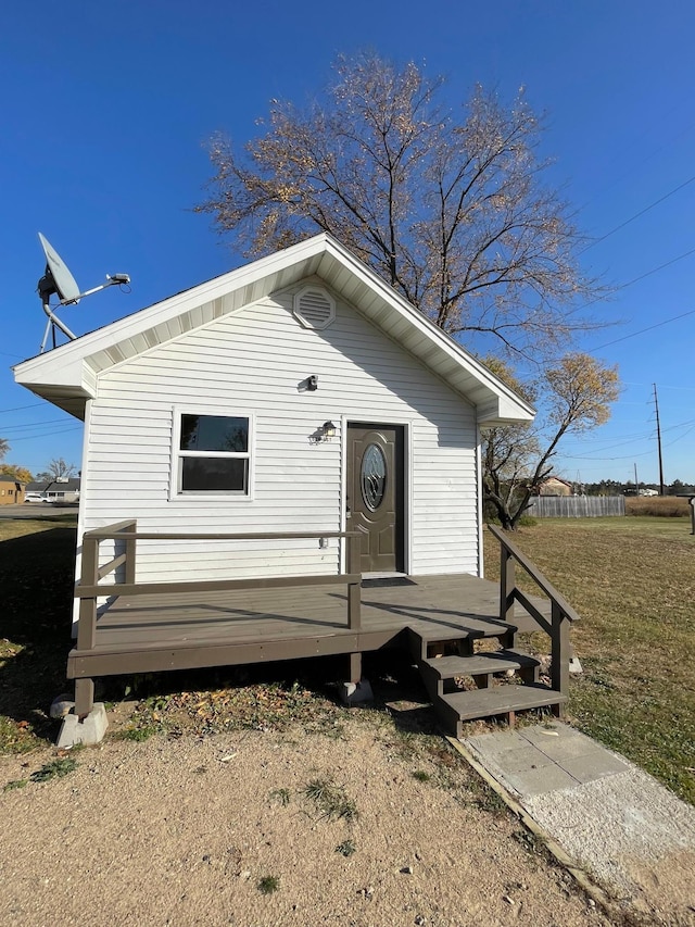 view of front of home featuring a front lawn and a deck