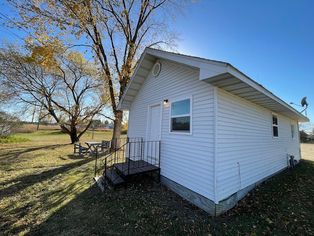 view of property exterior featuring a lawn