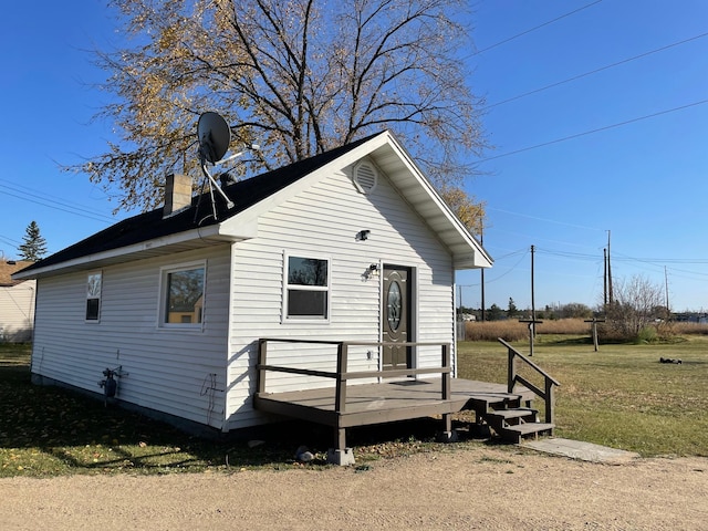 exterior space featuring a front yard and a deck