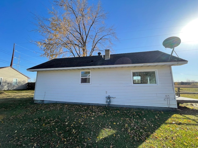 view of side of home featuring a lawn