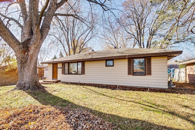 view of side of home featuring a lawn