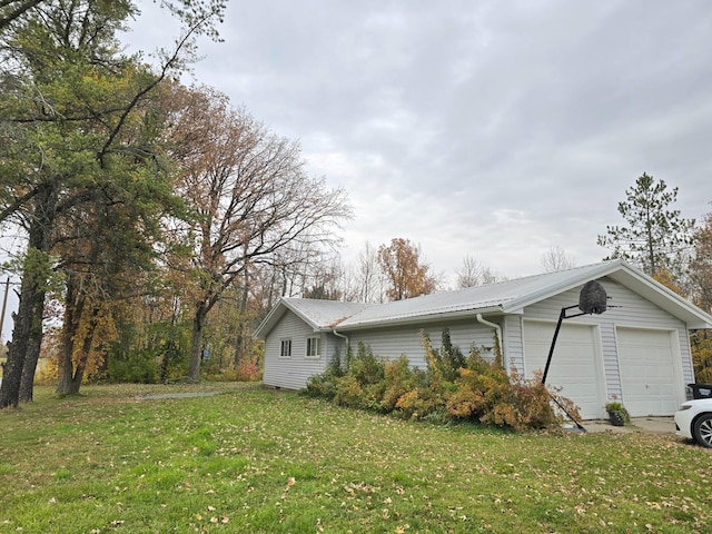 3414 County Road 32 S, South Koochiching Unorg Terr, MN 56654 - view of property exterior with a yard, metal roof, and a garage