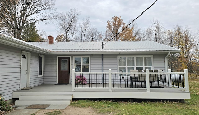 3414 County Road 32 S, South Koochiching Unorg Terr, MN 56654 - rear view of house featuring metal roof, a deck, and a chimney