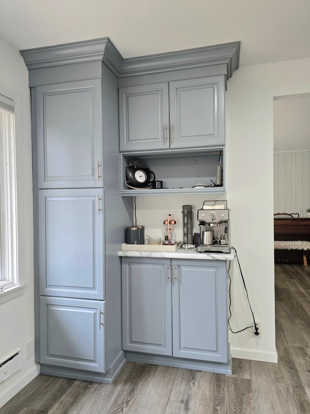 bar featuring gray cabinetry and dark hardwood / wood-style floors