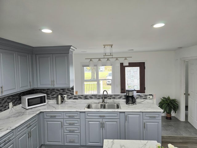3414 County Road 32 S, South Koochiching Unorg Terr, MN 56654 - kitchen with white microwave, a sink, gray cabinets, and tasteful backsplash