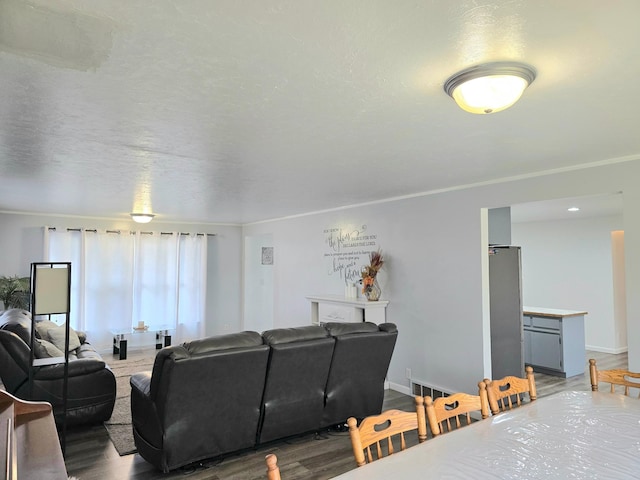 living room with crown molding and hardwood / wood-style flooring