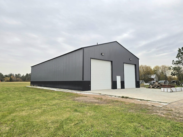 view of outbuilding featuring a lawn and a garage