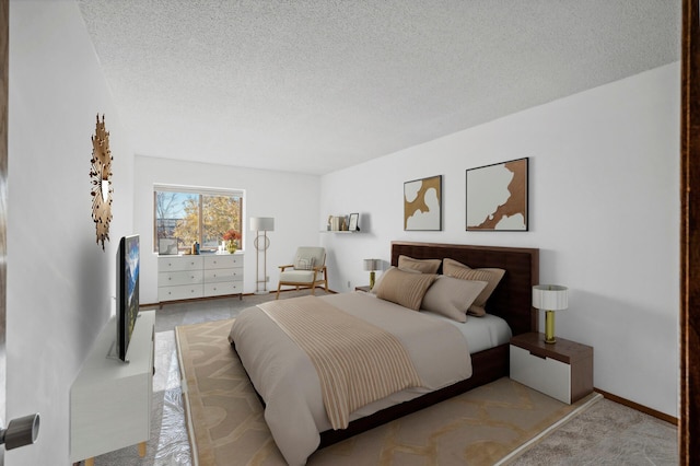 carpeted bedroom featuring a textured ceiling