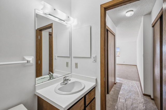 bathroom with vanity and a textured ceiling