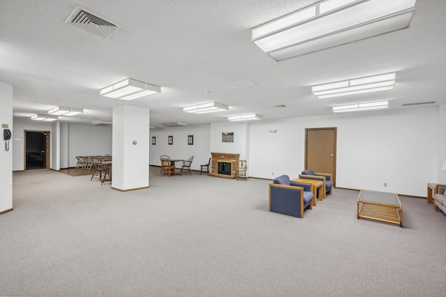 interior space with a textured ceiling and carpet floors