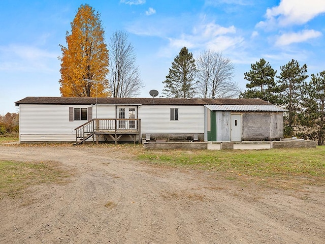 rear view of property with a wooden deck