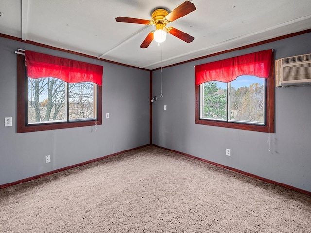 carpeted empty room featuring ceiling fan, a wall mounted AC, and a wealth of natural light