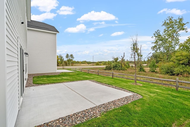 view of yard featuring a rural view and a patio