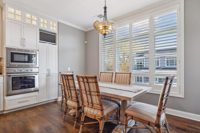 dining area featuring crown molding and dark wood-type flooring