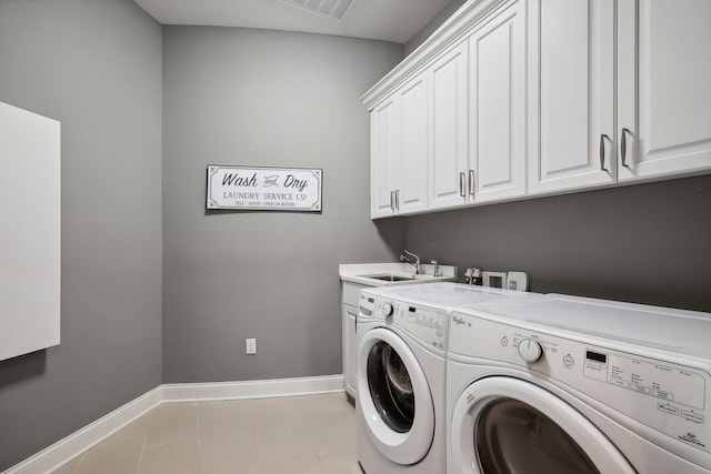 washroom with separate washer and dryer, sink, light tile patterned floors, and cabinets