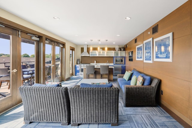 living room featuring sink and light colored carpet