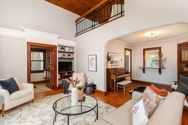 living room with hardwood / wood-style flooring, ornamental molding, and wood ceiling