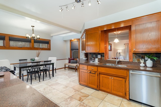 kitchen with stainless steel dishwasher, backsplash, sink, and pendant lighting