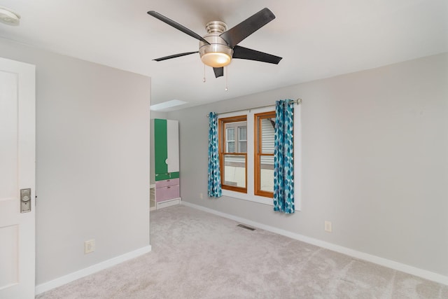 carpeted spare room with ceiling fan