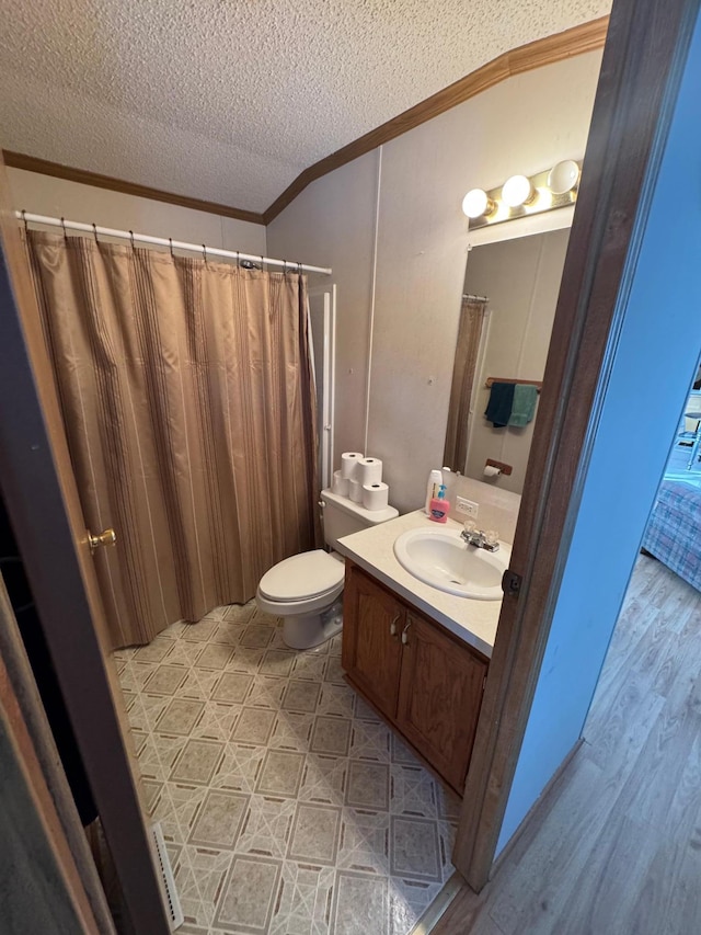 bathroom featuring a textured ceiling, vanity, toilet, walk in shower, and crown molding