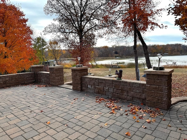 view of patio featuring a water view