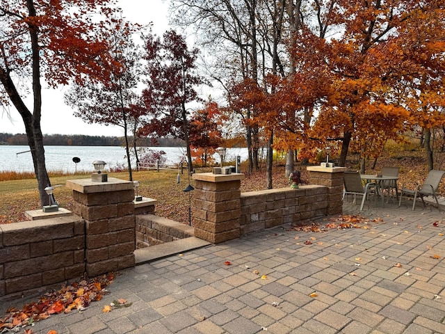 view of patio with a water view