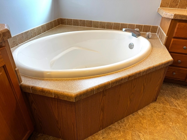 bathroom with a tub and tile patterned floors