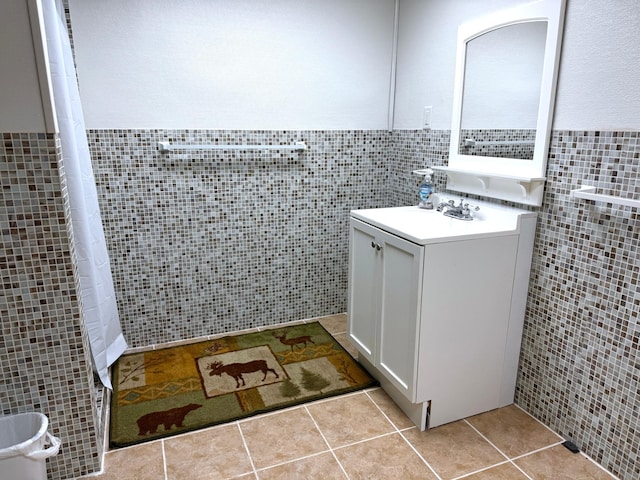 bathroom with vanity, tile patterned floors, and tile walls