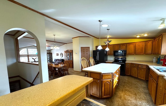 kitchen with lofted ceiling, hanging light fixtures, black appliances, crown molding, and a center island