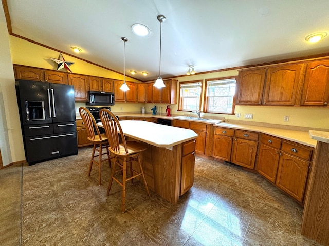 kitchen with lofted ceiling, hanging light fixtures, a kitchen island, a kitchen breakfast bar, and black appliances