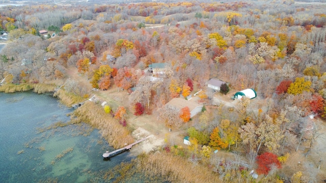 aerial view featuring a wooded view and a water view