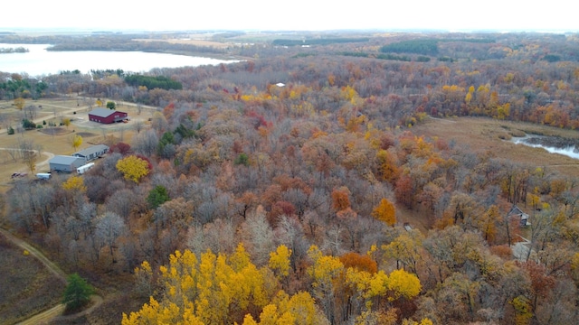 aerial view with a wooded view and a water view