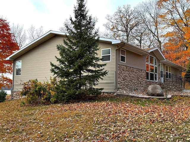 view of side of home with stone siding