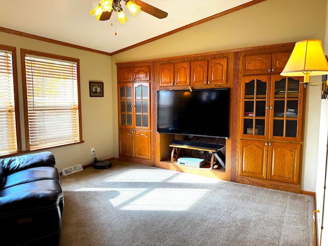 living room with visible vents, ceiling fan, ornamental molding, vaulted ceiling, and carpet flooring