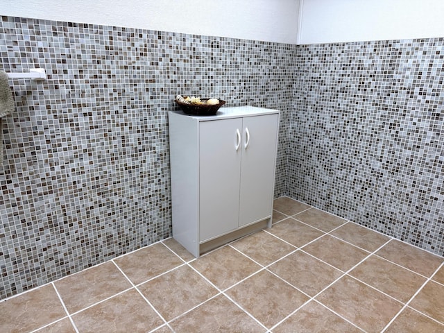 bathroom featuring tile patterned floors and tile walls