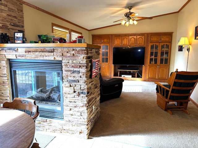 living area featuring carpet floors, a stone fireplace, crown molding, and vaulted ceiling