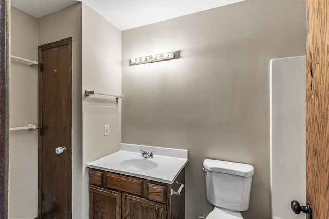 bathroom featuring toilet and vanity