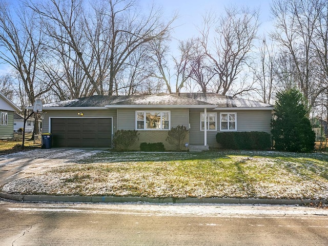 ranch-style home featuring a garage and a front lawn