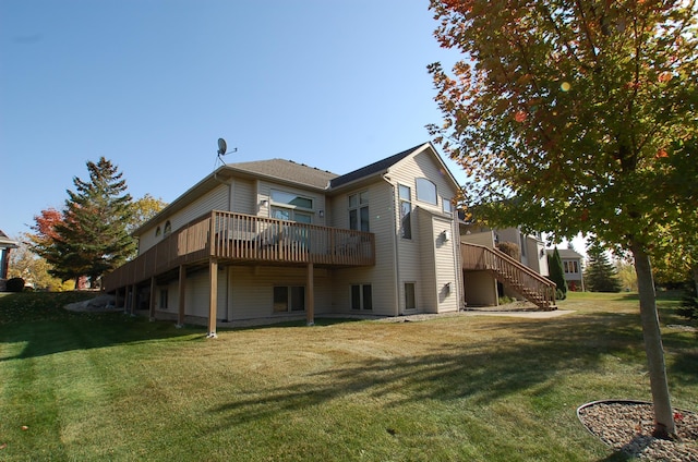 rear view of property with a lawn and a deck