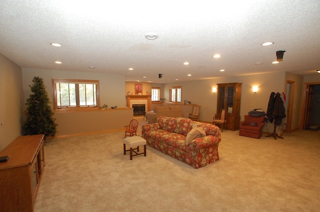 living room featuring light colored carpet and a textured ceiling