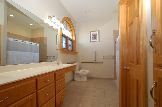 bathroom featuring toilet, vanity, tile patterned floors, and curtained shower