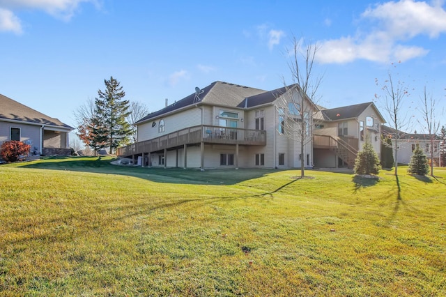 back of house with a lawn and a wooden deck