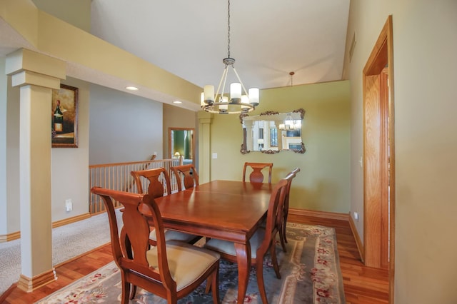 dining area with hardwood / wood-style floors and a notable chandelier