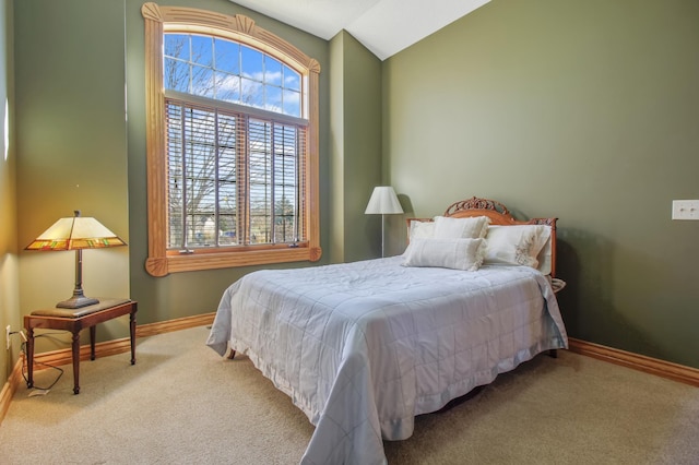 bedroom featuring carpet and vaulted ceiling