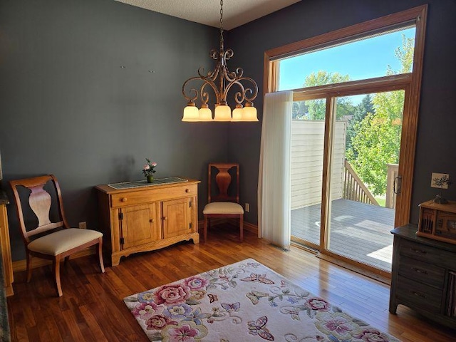 living area featuring wood-type flooring and a notable chandelier